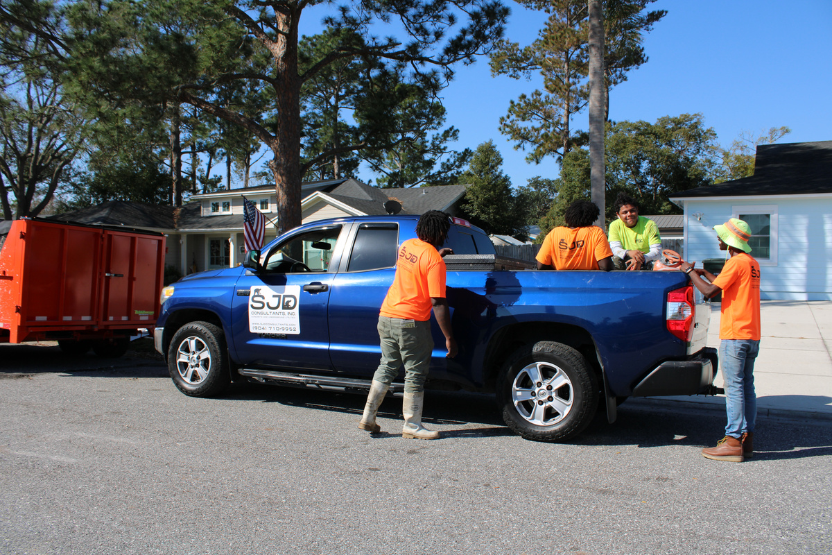 SJD Consultants crew with branded truck on job site